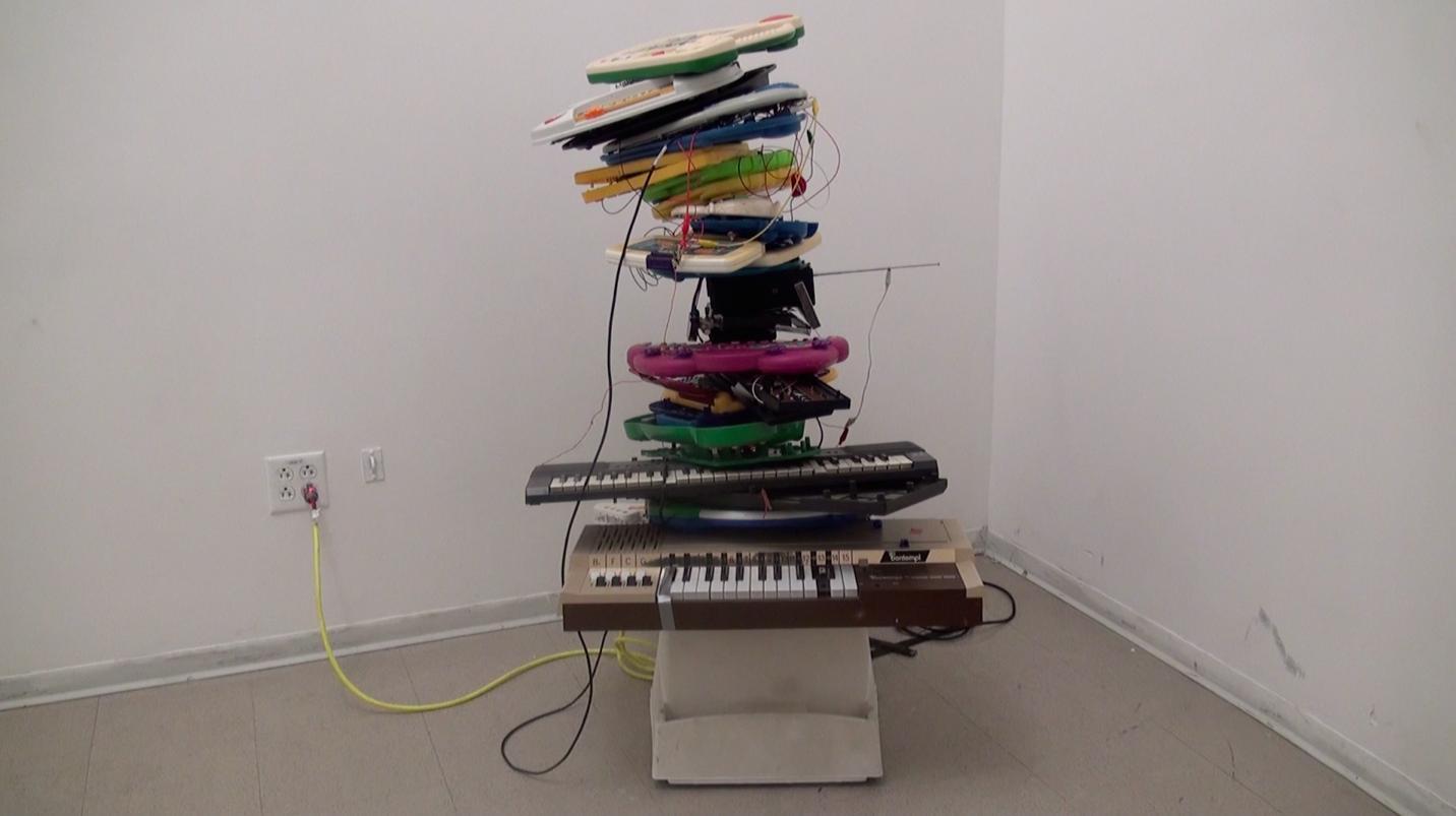 Sculpture 'Precarious Pile' by Nevada Hardman. A towering stack of circuit-bent children's toys assembled into an unstable form.