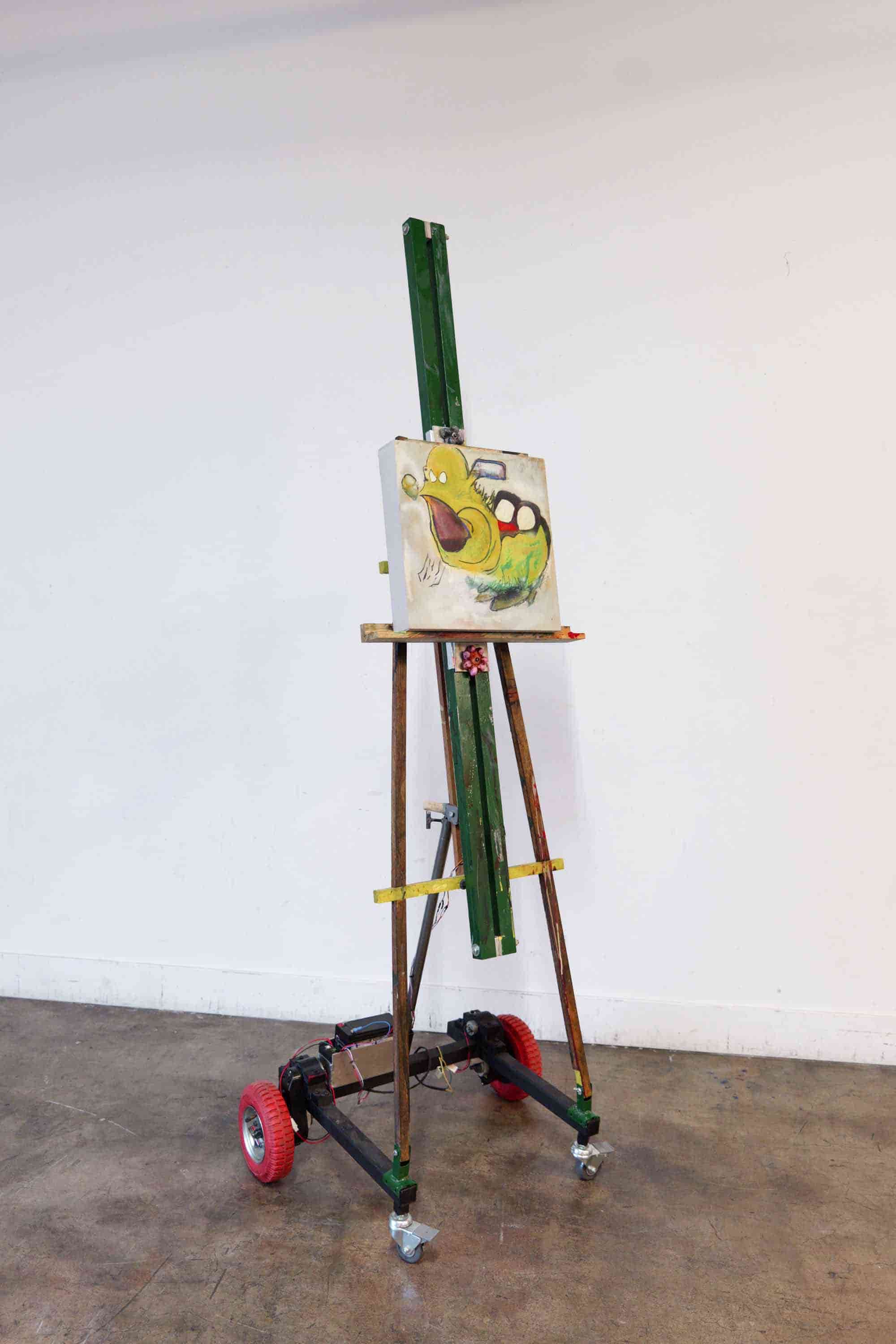 Interactive kinetic sculpture 'Jester of a Sentient Chassis' by Nevada Hardman. Autonomous robotic eisel. 2024. Motor, painting